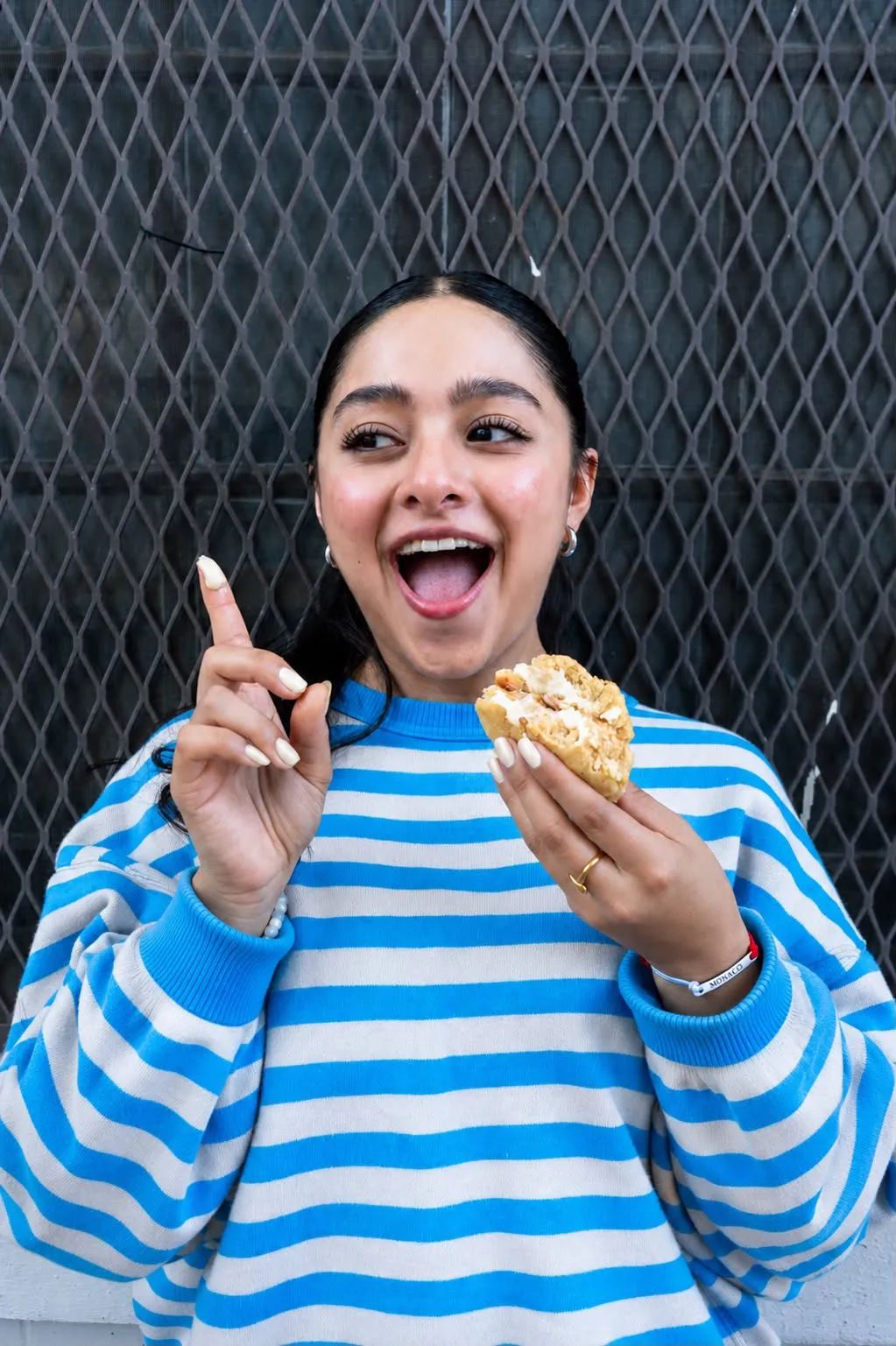 A customer laughing while eating a filled For You cookie